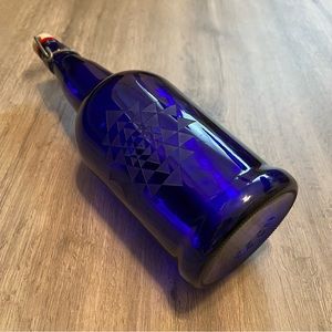 Beautiful blue glass bottle with swing porcelain cap